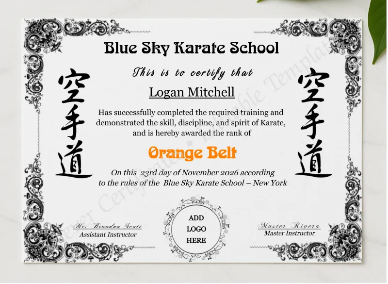 Karate Orange Belt Certificate With Logo presented in a sleek wooden frame, elegantly arranged on a stylish table.